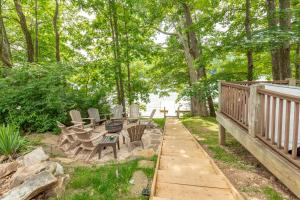 a deck with a table and chairs in a yard at Corks Away by Railey Vacations in McHenry