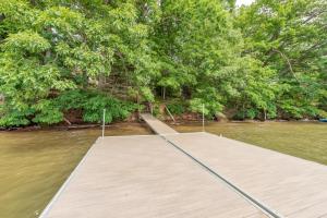 a wooden dock in the middle of a river at Corks Away by Railey Vacations in McHenry