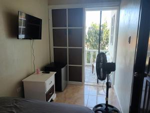 a bedroom with a door open to a patio at Habitación Taina in Jarabacoa
