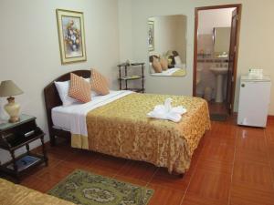 Postel nebo postele na pokoji v ubytování Hotel Suite Plaza