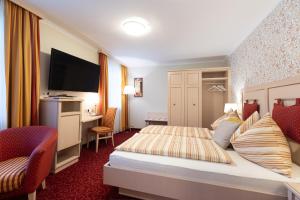 a hotel room with a bed and a desk at Schliefauhof in Randegg +71 photos