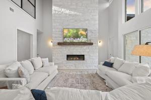 a living room with white couches and a fireplace at LBJ Retreat in Kingsland