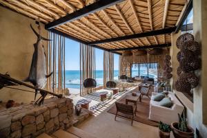 a living room with a view of the ocean at Inkaterra Cabo Blanco in Talara +8 photos
