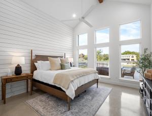 a bedroom with a bed with a table and windows at LBJ Retreat in Kingsland +50 photos