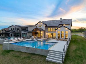 a large house with a swimming pool in front of it at LBJ Retreat in Kingsland