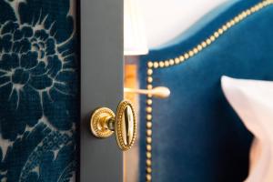 a door with a gold door knob on it at La Chambre du Marais in Paris