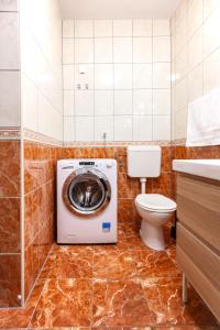 a bathroom with a washing machine and a toilet at Apartmani Vale 2 in Hvar +22 photos
