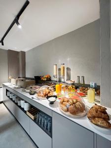 a kitchen with several plates of bread and pastries at Hotel NOVA Inn Sarajevo in Sarajevo +26 photos