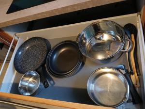 a bunch of pots and pans in a drawer at Logement dans la campagne nérisienne in Néris-les-Bains +8 photos