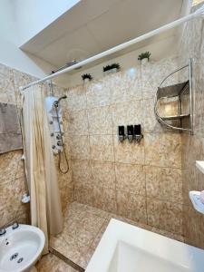 a bathroom with a shower and a sink at Fortuna Apart in General Roca
