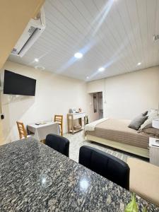 a hotel room with a bed and a table and chairs at Fortuna Apart in General Roca