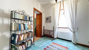 a room with a book shelf filled with books at La Torretta - Authentic Historic House with Panoramic Sea-View Terrace in Otranto Old Town - Marea Stays Collection in Otranto