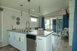 a kitchen with a sink and a counter top at Sun Outdoors Association Island in Henderson Harbor