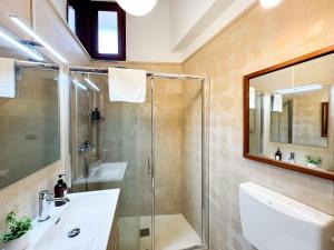 a bathroom with a shower and a sink at La Torretta - Authentic Historic House with Panoramic Sea-View Terrace in Otranto Old Town - Marea Stays Collection in Otranto +51 photos