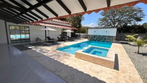 a swimming pool in the backyard of a house at Villa Serena Sopetran in Sopetrán