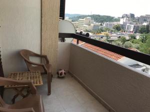 a balcony with a chair and a soccer ball at Apartment Dream in Boreti +3 photos