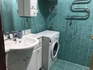 a bathroom with a sink and a washing machine at Apartment Dream in Boreti
