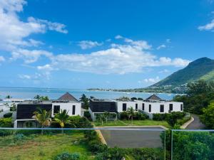 a house with a view of the ocean at Beachfront sea view apartment in Petite Case Noyale