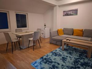 a living room with a couch and a table at FLAMANITA APARTMENTS in Skopje
