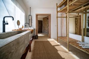 a kitchen with a long counter and a hallway at Inkaterra Cabo Blanco in Talara