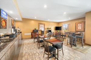 a restaurant with tables and chairs and a bar at Americas Best Value Inn Somerville Texas in Somerville