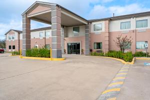 a building with a parking lot in front of it at Americas Best Value Inn Somerville Texas in Somerville