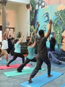 a group of people in a yoga class at El Pinche Hostal in Guadalajara