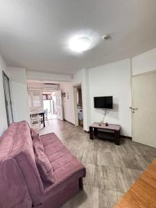 a living room with a couch and a tv at Mystras Apartments in Kotor