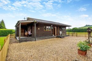 a small wooden cabin with a gravel yard at 2 Bed in Somerton oc-w29203 in Somerton