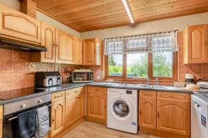 a kitchen with wooden cabinets and a washer and dryer at 2 Bed in Somerton oc-w29203 in Somerton