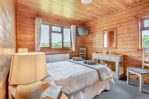 a bedroom with a bed and a desk and a television at 2 Bed in Somerton oc-w29203 in Somerton