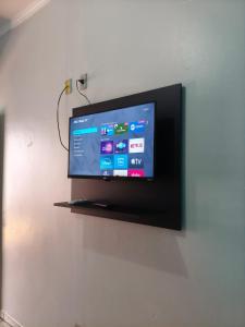 a flat screen tv hanging on a wall at Pousada Costa Brasil Engenheiro Beltrao in Engenheiro Beltrão
