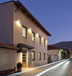 a building on a city street at night at Hotel NOVA Inn Sarajevo in Sarajevo