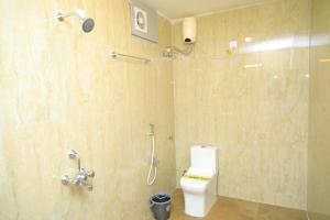 a bathroom with a toilet and a shower at Malar Inn Resort in Covelong +22 photos