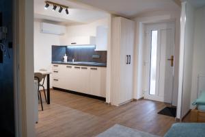 a kitchen with white cabinets and a table in a room at Ubytování U Mecha in Bečice
