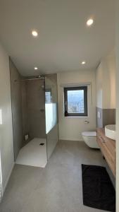 a bathroom with a shower and a toilet and a sink at Chez Pomme in Brussels +37 photos