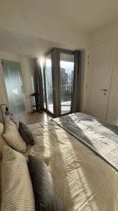 a large bed with pillows on it in a bedroom at Chez Pomme in Brussels