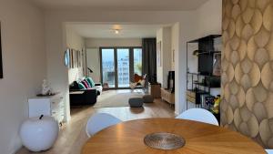 a living room with a table and a couch at Chez Pomme in Brussels