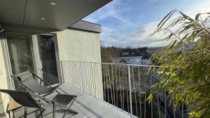 two chairs on the balcony of a house at Chez Pomme in Brussels