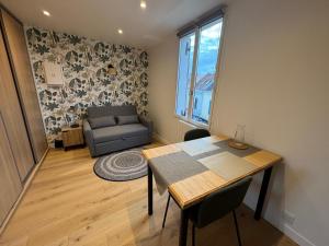 a living room with a table and a couch at Appartement hyper centre Amiens in Amiens +7 photos