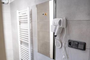a bathroom with a blow dryer on the wall at Ubytování U Mecha in Bečice +23 photos