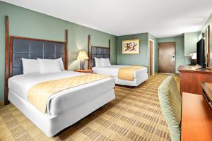 a hotel room with two beds and a television at Americas Best Value Inn Somerville Texas in Somerville +18 photos