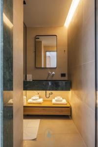une salle de bains avec un lavabo et un miroir dans l'établissement Pine Hotel & Spa Brezovice, à Brezovicë 38 autres photos