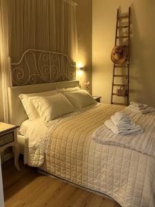 a bedroom with a white bed with towels on it at Armonia - Casa Vacanze in Spello