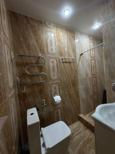 a bathroom with a toilet and a shower at Sunny Village Hotel in Haghpat