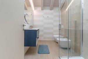 a bathroom with a toilet and a glass shower at Apartment-Boutique Stella in Cittadella