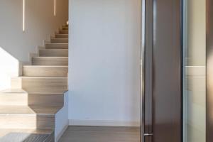 a staircase in a house with a glass door at Apartment-Boutique Stella in Cittadella +20 photos