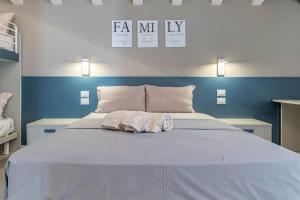 a large bed with two towels on top of it at Apartment-Boutique Stella in Cittadella