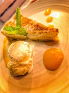 a plate of food with a piece of fish and sauce at Kampasi Olmoingo Camp in Talek +13 photos