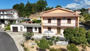 a house with an umbrella in front of a street at Al Giardino b&b in Acri